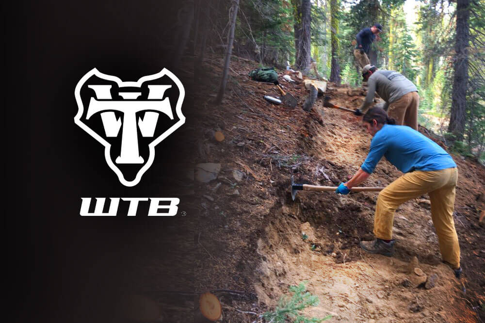 WTB logo and workers on trail