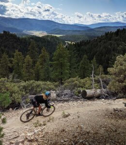 Woman bike racer in the mountains above the Quincy Meadows