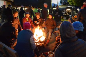 People gathered around fire pit