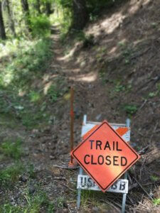 Trail closed sign on trail