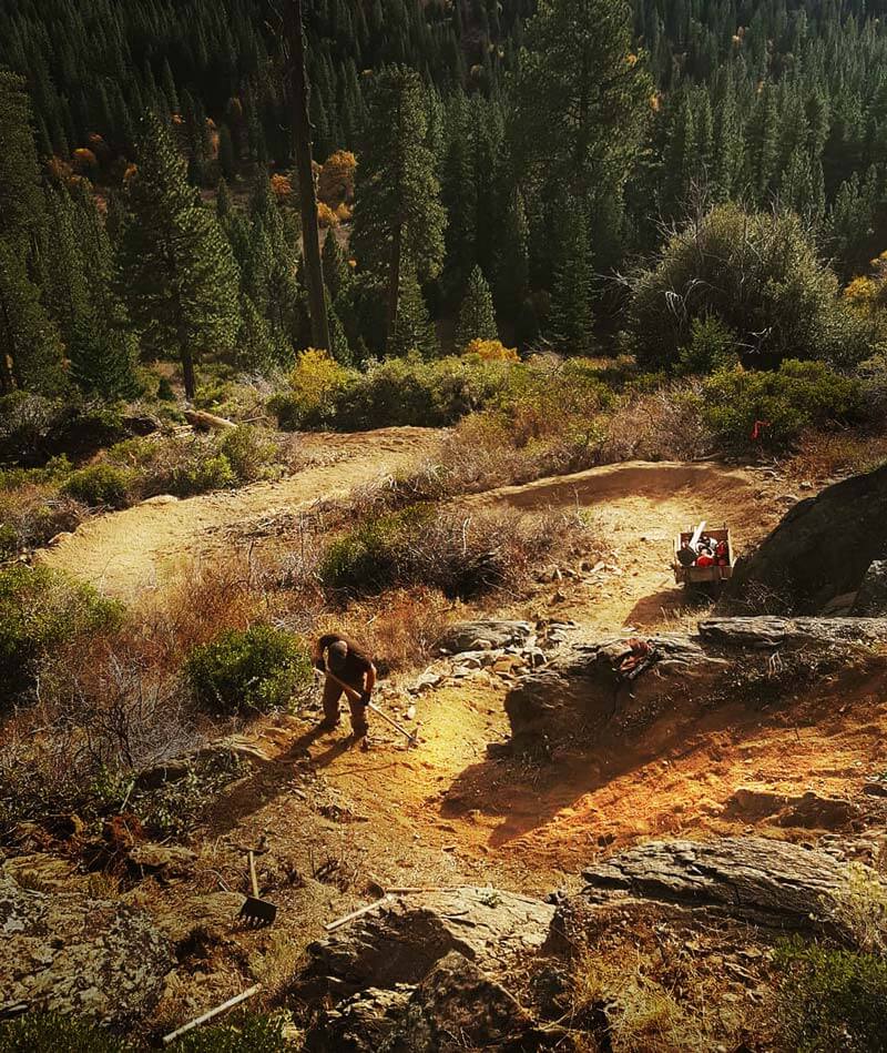 Trail worker digging trail.