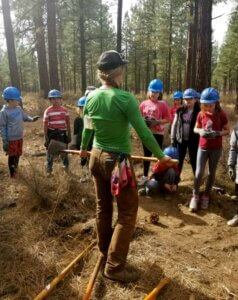 Instructor with tool teaching school kids.