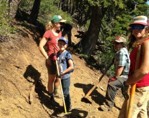 Young and old on a trail with trail tools