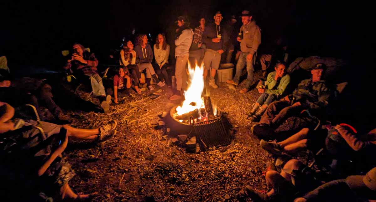 Large group of people around fire pit